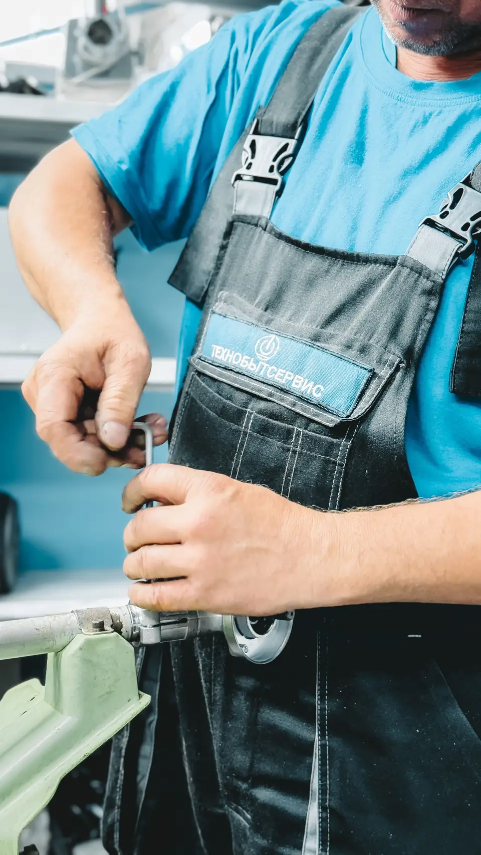 Close view of a tradesperson using a wrench on indoor pipework